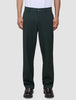 Person wearing exceptionally soft, dark green Ease Pants Relaxed Fit Northern Pine tailored trousers and dark loafers.