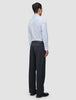 Seen from behind, a person wears an Elevated Shirt Regular Classic Blue Striped, an elegant, light blue, vertically striped pima cotton button-up shirt paired with dark charcoal trousers.