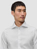 A man wearing an Elevated Shirt White Slim Pima cotton dress shirt with a spread collar and slim fit.