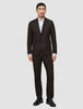 A man wearing a Motion Blazer Slim Cognac over a white collared shirt with black dress shoes.