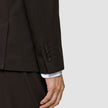 Close-up of the Motion Blazer Slim Cognac sleeve in lightweight, breathable fabric, featuring four buttons at the cuff and a white shirt cuff visible underneath.