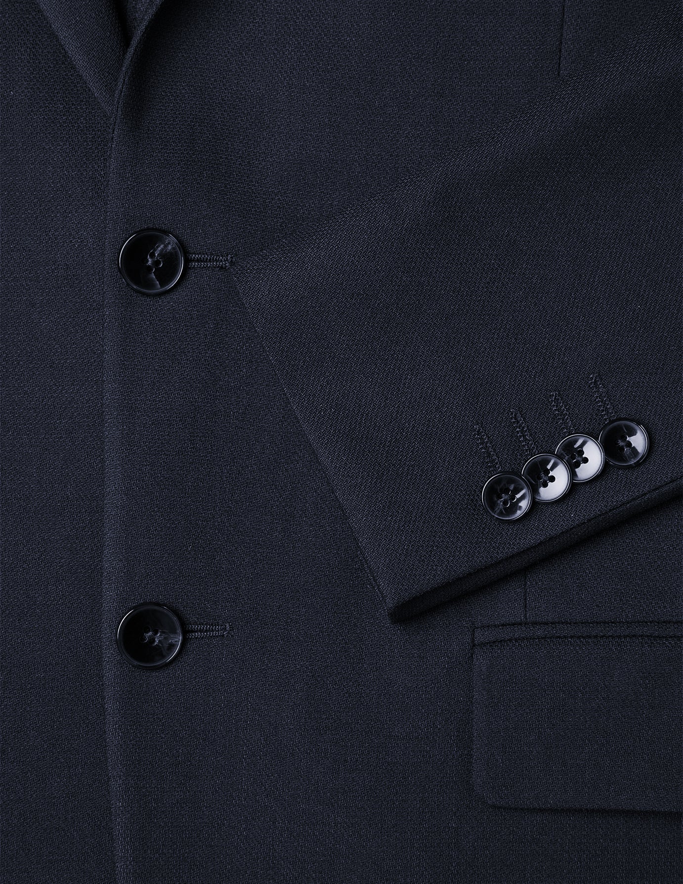 Close-up of a Motion Blazer Slim Midnight Blue showing the 360° stretch fabric, front button closure, four-button sleeve cuff, and a pocket.