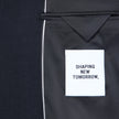 Interior view of a dark blue Motion Blazer Slim Midnight Blue, showing a white SHAPING NEW TOMORROW label stitched to the black lining of the 360° stretch tailored blazer.