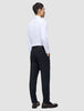 A man viewed from behind, wearing a white button-down shirt and Motion Suit Pants Regular Midnight Blue with his hands in his pockets.