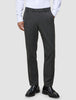 A man wearing Motion Suit Pants Regular Pepper Grey, a white button-down shirt, and black loafers.