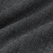 Close-up of Motion Suit Pants Regular Pepper Grey in gray fabric with a textured, 360° stretch knit-like weave gathered into folds.
