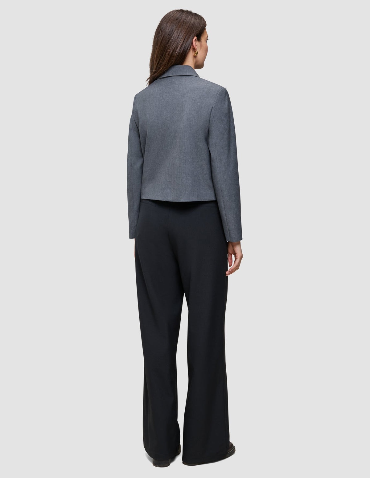 A person seen from behind wearing a grey blazer and black high-waist, wide-leg Serene Pants Wide Black.