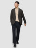 A person wears a Timeless Wool Blazer Slim Dark Brown Check over a tan turtleneck sweater, paired with black trousers and black loafers.