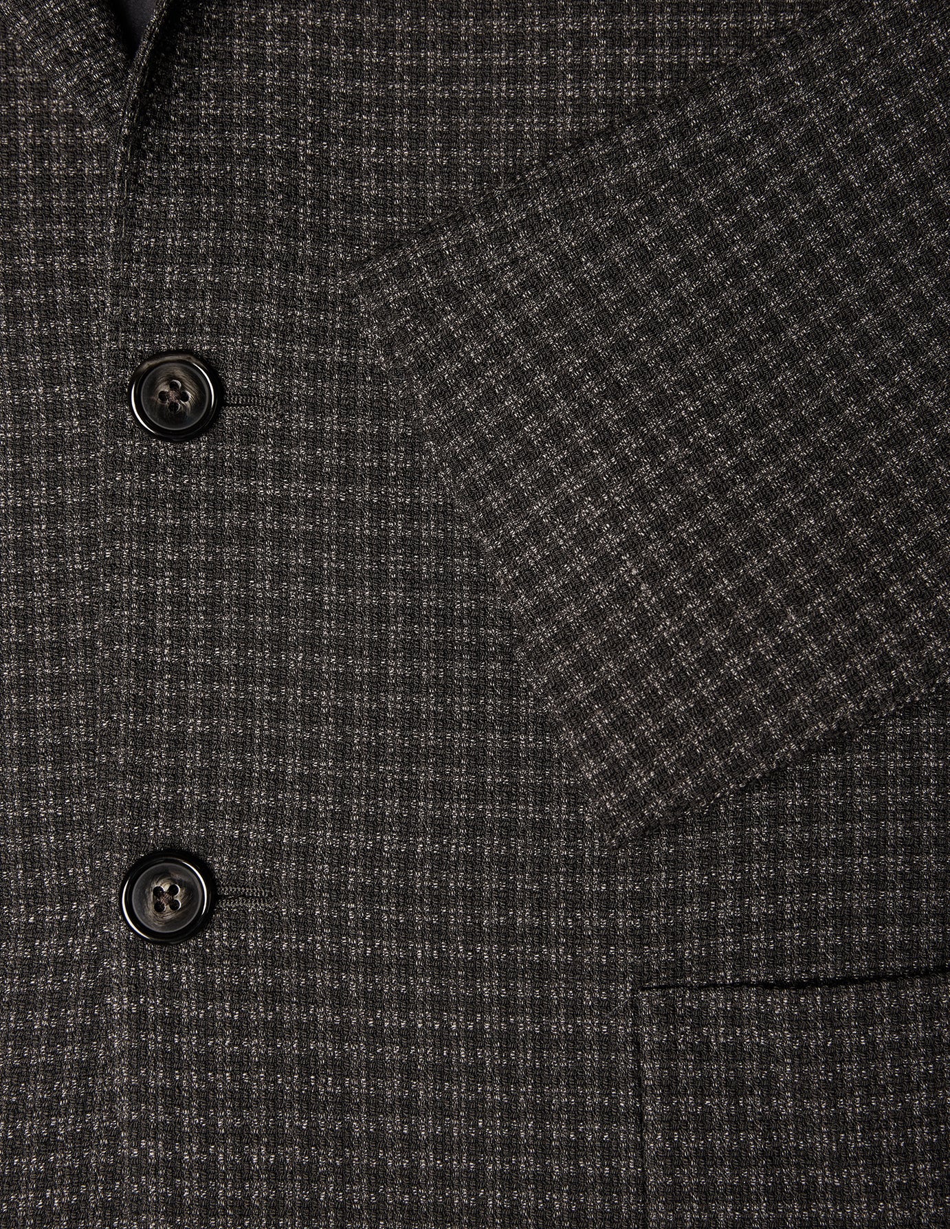 Timeless Wool Blazer Slim Dark Brown Check: slim fit dark brown wool blazer with a small grid pattern, two dark buttons, and sleeve detail.