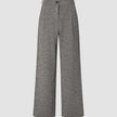 Women Ashryn Pants Wide Domino Herringbone: high-waisted wide-leg trousers in a black and white herringbone bouclé, featuring a button closure and front pleats in a classic Scandinavian design.