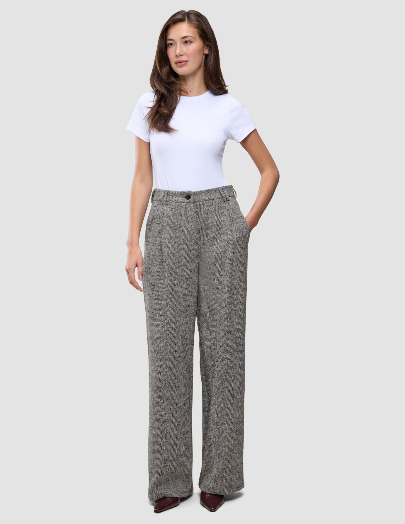 A woman wearing a white t-shirt and grey herringbone bouclé wide-leg Women Ashryn Pants Wide Domino Herringbone.