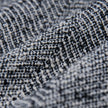 Close-up of the black and white textured herringbone bouclé weave on the Women Ashryn Pants Wide Domino Herringbone.