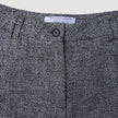 Close-up of the waistband and button closure of Women Ashryn Pants Wide Domino Herringbone in gray and black.