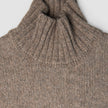 Women Chunky Soft Wool Knit Turtleneck Taupe Melange sweater featuring a chunky knit and a ribbed turtleneck.
