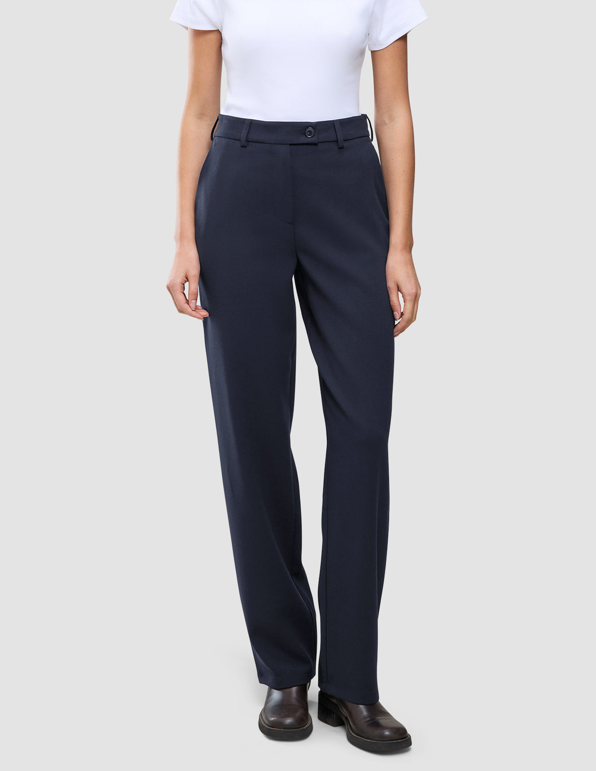 Person wearing Women GO2 Pants Straight Blue Nights high-waisted, straight-leg navy blue trousers and a white t-shirt.