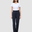 A woman wearing a white t-shirt tucked into Women GO2 Pants Straight Blue Nights, which are high-waisted, straight-leg dark blue trousers.