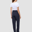 A woman seen from behind wearing a white t-shirt and Women GO2 Pants Straight Blue Nights, which are dark blue high-waisted, straight-leg trousers.