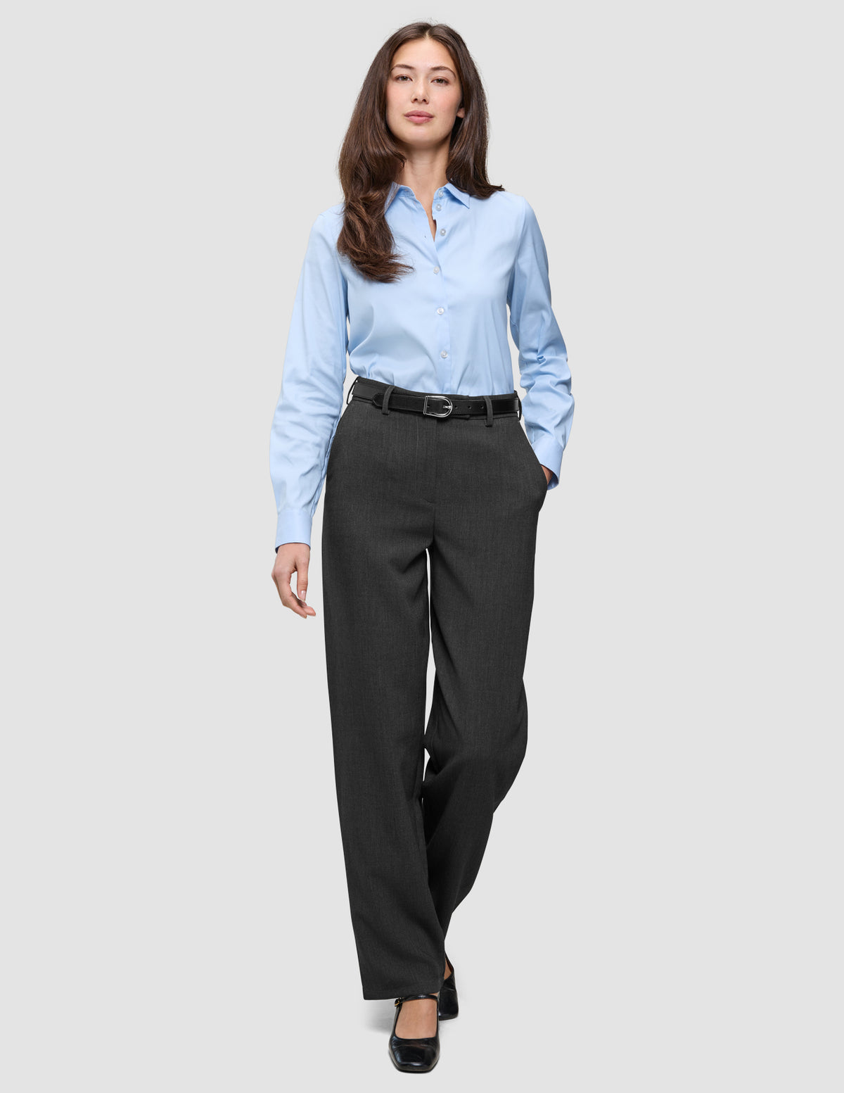 A woman wears a light blue button-down shirt with Women GO2 Pants Straight Dark Grey Melange, featuring a black belt.