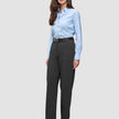 A woman wearing a light blue button-down shirt, a black belt, Women GO2 Pants Straight Dark Grey Melange, and black block-heel shoes.