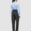 A woman viewed from behind, wearing a light blue button-up shirt and Women GO2 Pants Straight Dark Grey Melange with a black belt.
