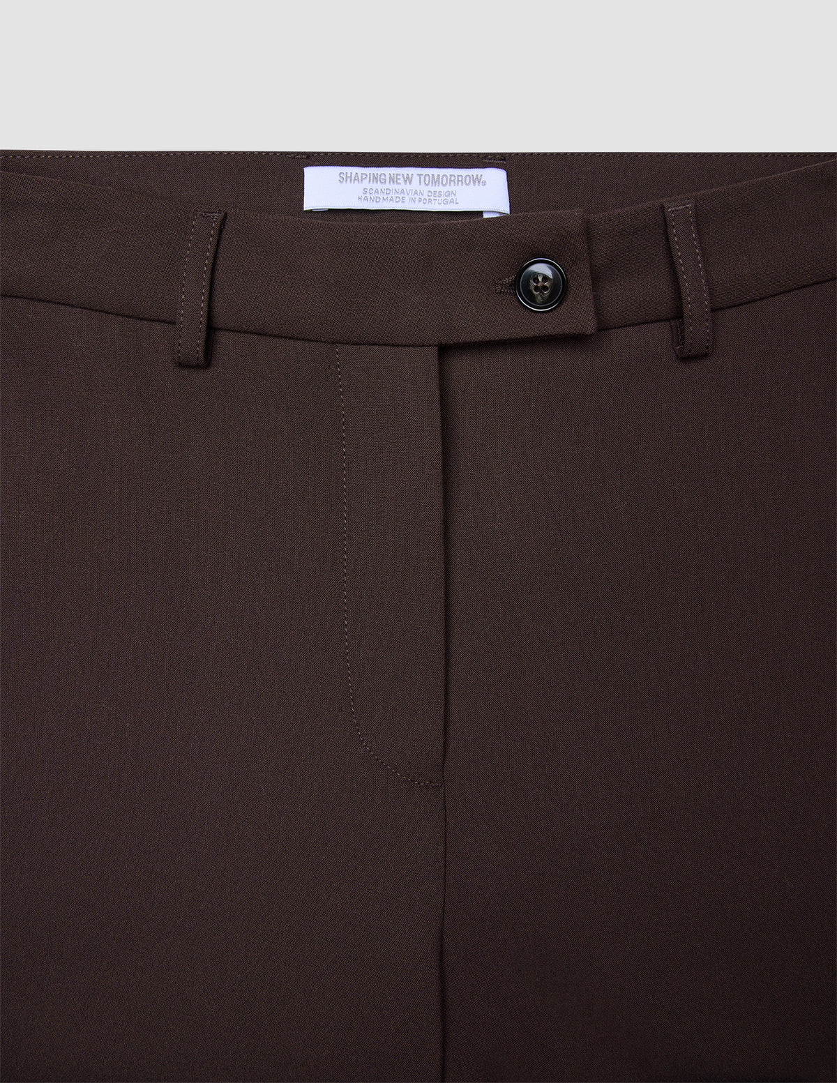 Close-up of the waistband and fly of Women GO2 Pants Straight Mocha, featuring a single button closure and belt loops in a dark brown, Scandinavian-inspired design.
