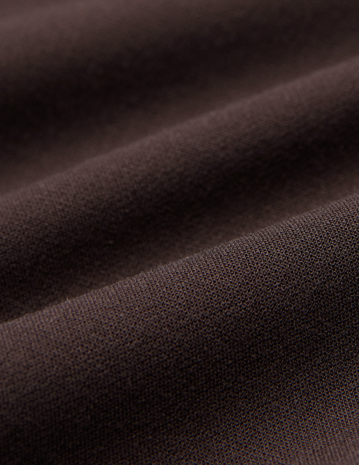 Close-up of brown fabric with a visible knit texture and gentle folds, shown here in Women GO2 Pants Straight Mocha.