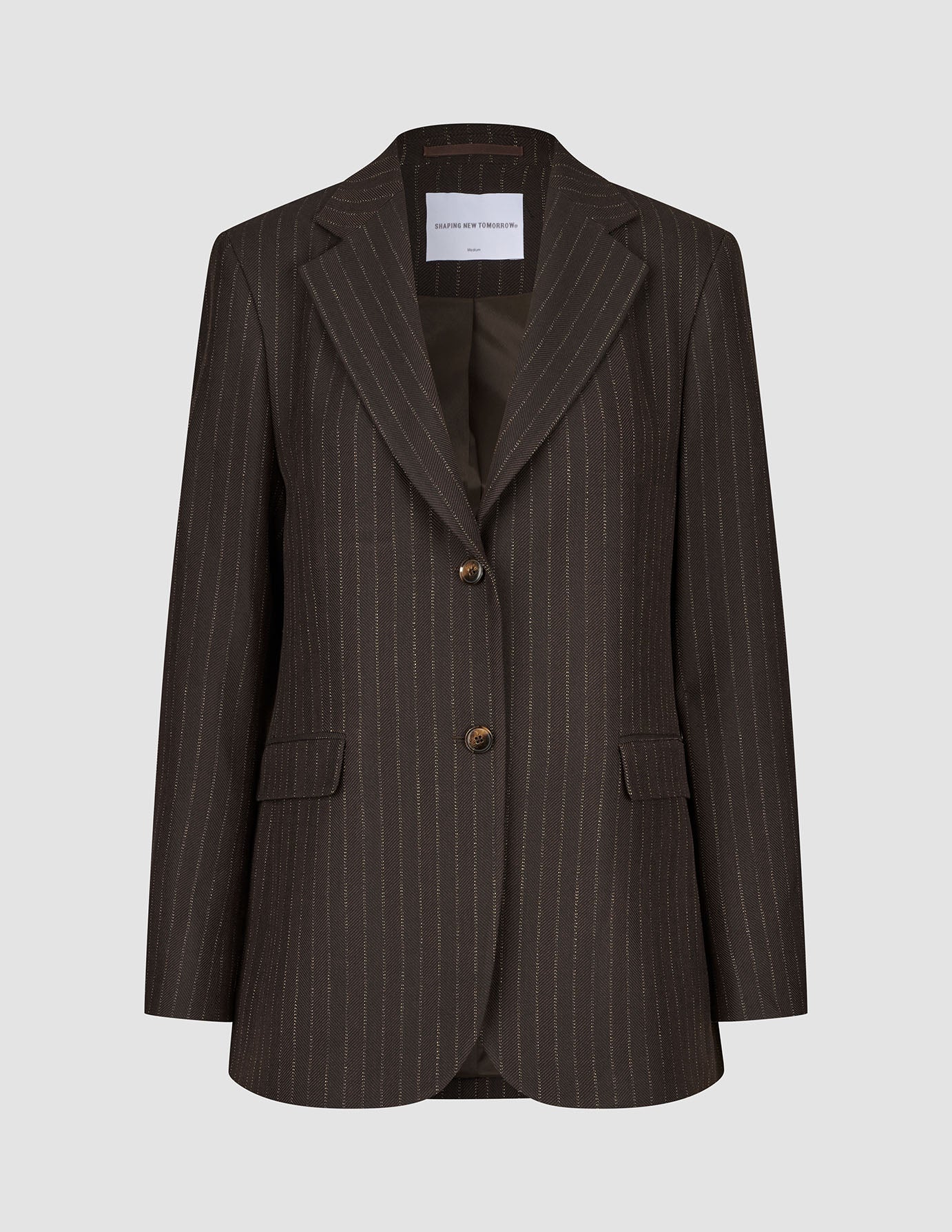 Women Serene Blazer Regular Walnut Herringbone in brown wool with a herringbone texture, two front buttons, and flap pockets in a classic Scandinavian design.