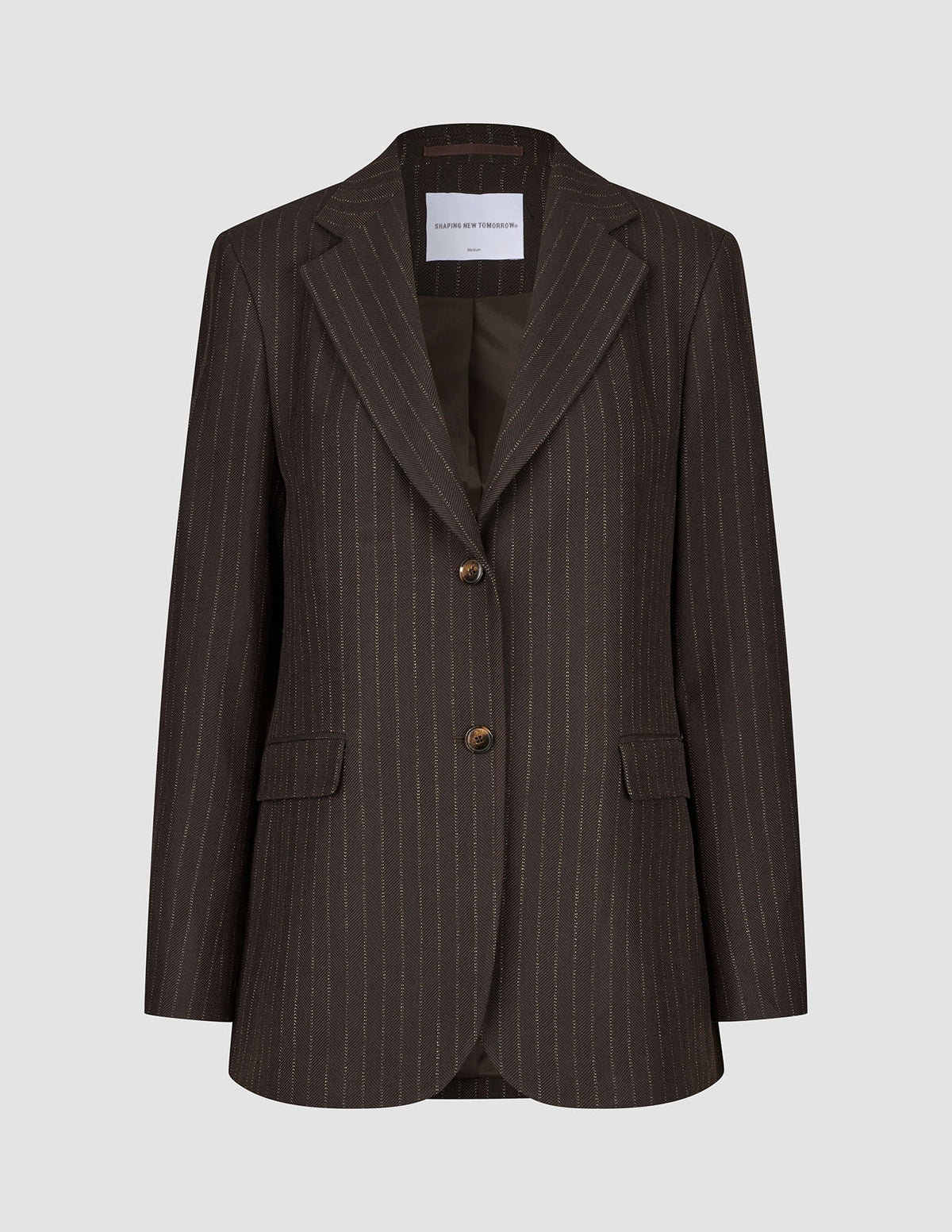 Women Serene Blazer Regular Walnut Herringbone in brown wool with a herringbone texture, two front buttons, and flap pockets in a classic Scandinavian design.