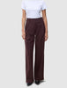 Women Serene Pants Wide Berry Pinstripe are high-waisted, wide-leg trousers in a dark berry color with thin vertical pinstripes, featuring a minimalist Scandinavian design.