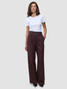 A woman wears a white t-shirt and Women Serene Pants Wide Berry Pinstripe, featuring a wide-leg, high-waisted design that reflects a clean Scandinavian aesthetic.