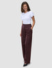 A woman wears a white t-shirt and Women Serene Pants Wide Berry Pinstripe in a Scandinavian design.