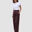 A woman wears a white t-shirt and Women Serene Pants Wide Berry Pinstripe in a Scandinavian design.