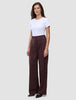 A woman wears a white t-shirt tucked into Women Serene Pants Wide Berry Pinstripe.