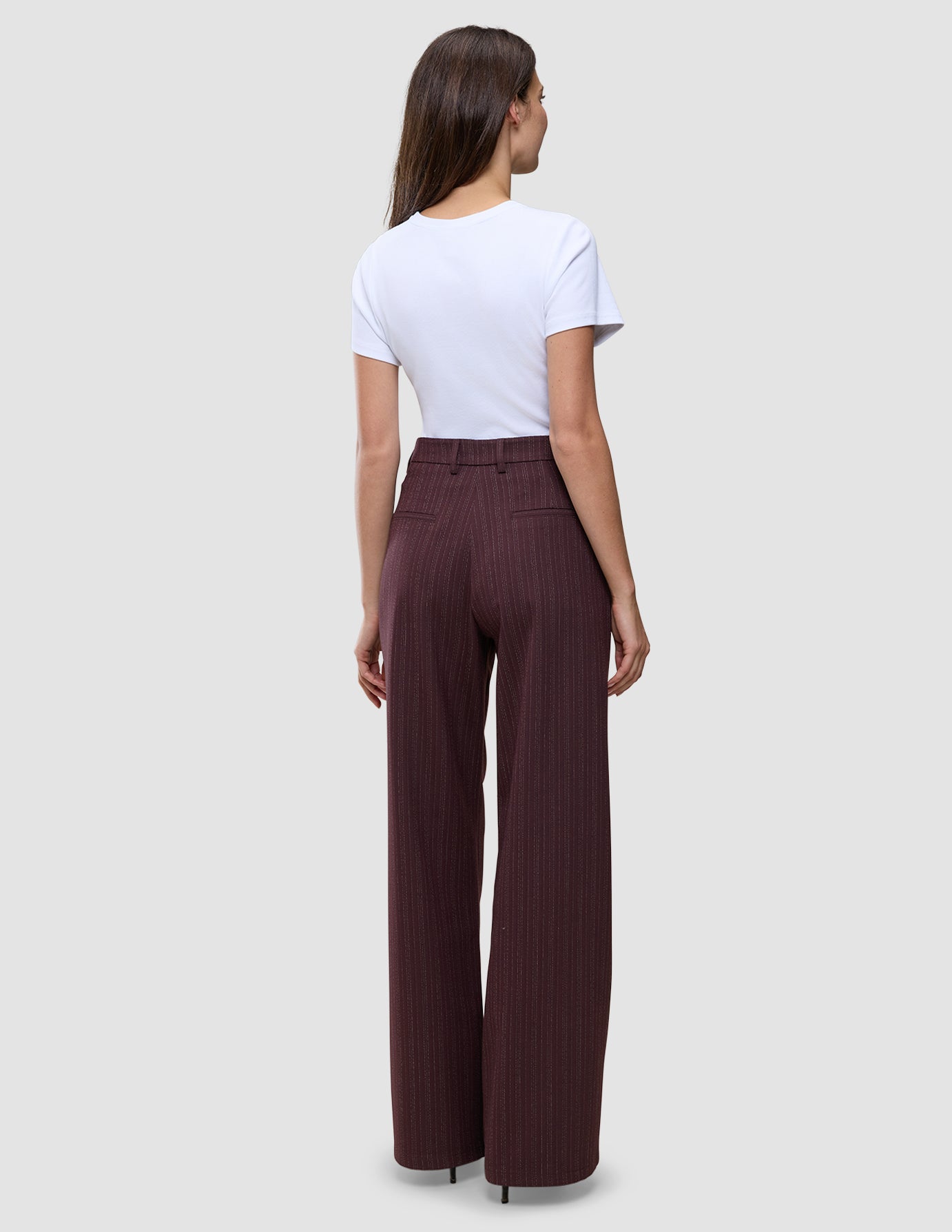 A person viewed from the back, wearing a white t-shirt and Women Serene Pants Wide Berry Pinstripe.