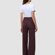 A person viewed from the back, wearing a white t-shirt and Women Serene Pants Wide Berry Pinstripe.